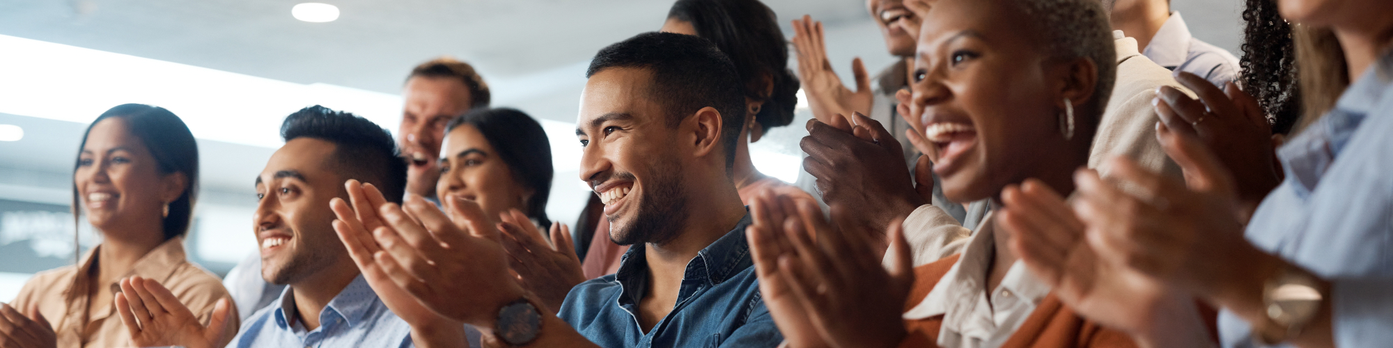 a group of people clapping and smiling 