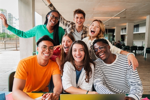 Group of young students smiling/posing for picture