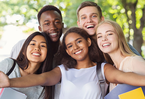 A group of young individuals joyfully smiling together.