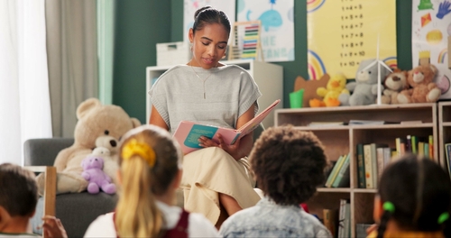 kindergarten teacher reading to children