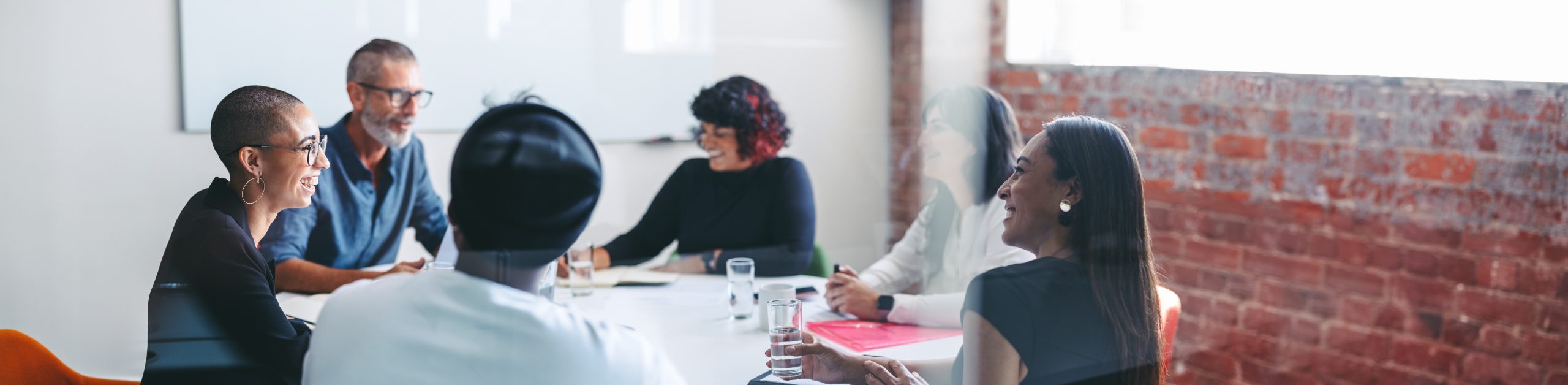 Team of businesspeople having a discussion during a meeting. Group of creative businesspeople attending their morning briefing in an office. Businesspeople working together as a team.