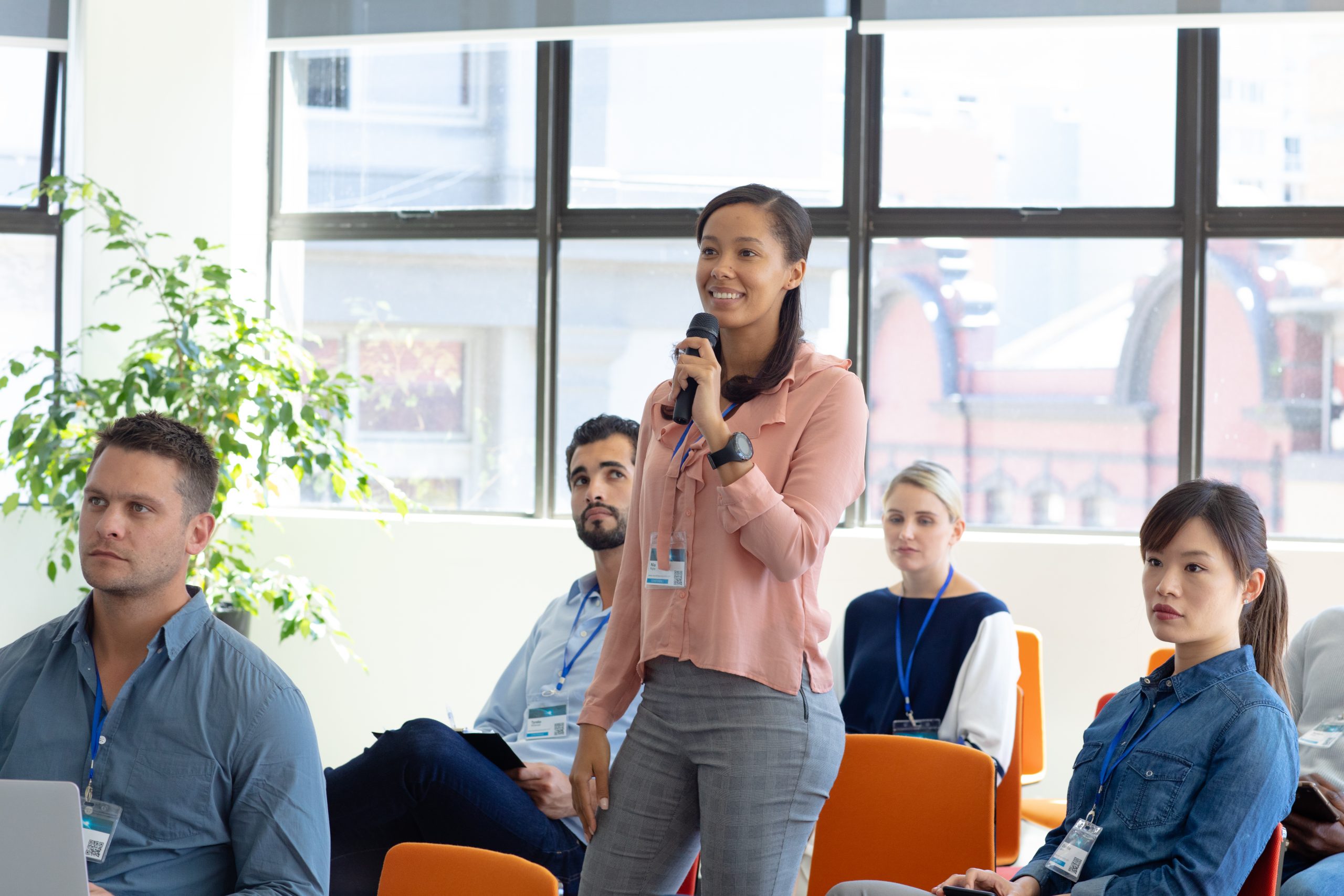 Conference session with woman raising her hand