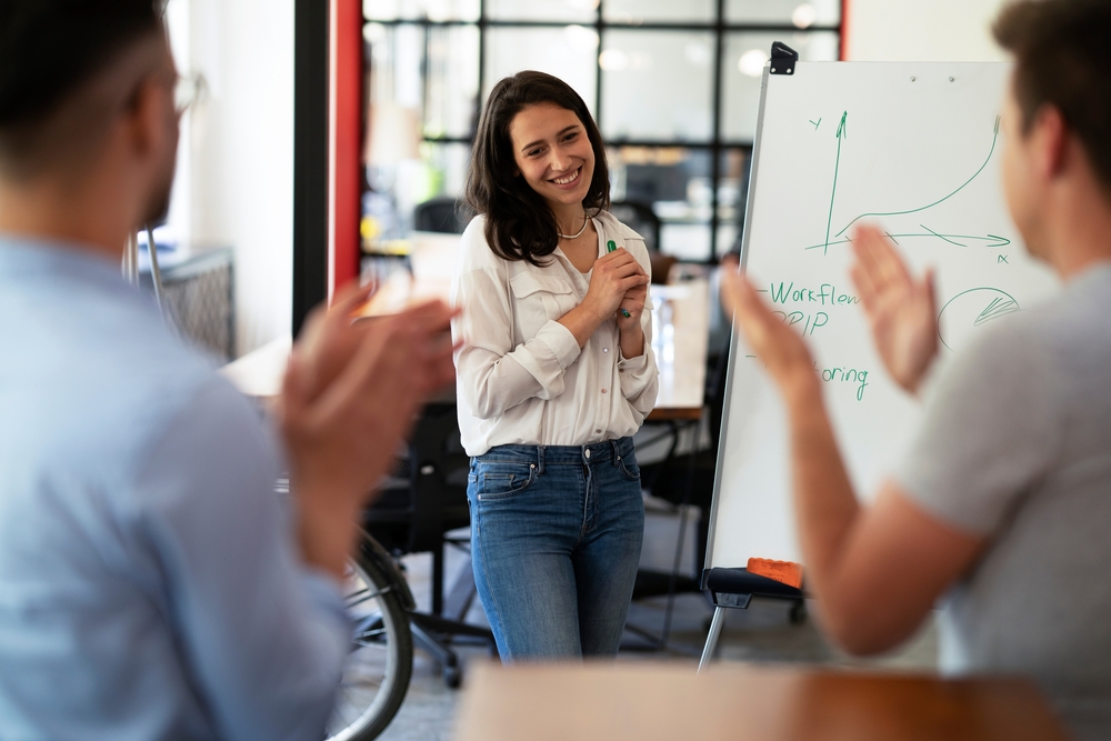 African American woman writing on whiteboard and leading a discussion